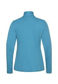 Veste à manches longues et col montant en bleu clair, fabriquée dans un matériau texturé. Présente des coutures lisses et un design ajusté sans détails supplémentaires.