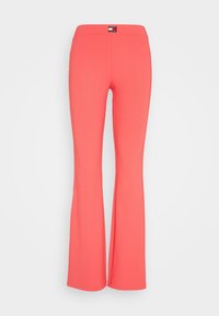 Korala, prążkowane spodnie dzwony z elastycznym paskiem w talii oraz małą, czarno-białą naszywką z logo Tommy Jeans na środku przodu w talii.