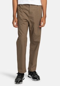 Brown, lightweight cotton pants with a straight leg design, featuring an elastic waistband and side pockets. Worn with black athletic shoes.