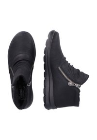 Black ankle boots made from leather with a soft texture. Features side zippers and a chunky rubber sole for added comfort and grip.