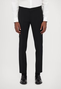 Schwarze, maßgeschneiderte Hose mit geradem Bein, aus einem glatten Material, mit seitlichen Taschen und Knopfakzenten am Bund.