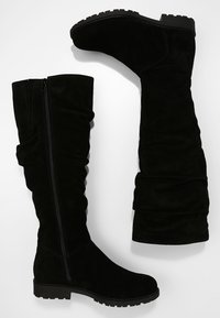 Mustat samettiset ylipolvensaappaat, joissa on rypytetty muotoilu, sivu veto- ja karkeat kumipohjat pitoa varten. Tasainen pinta kauttaaltaan.