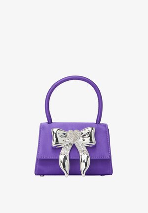 Purple handbag made of smooth material, featuring a metallic heart-shaped bow clasp. Small size with a rounded handle and neat stitching.