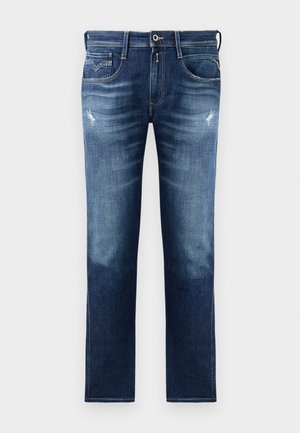 Blue denim jeans with a regular fit, featuring a faded wash, slight distressing, five pockets, and contrast stitching. Button closure at waist.