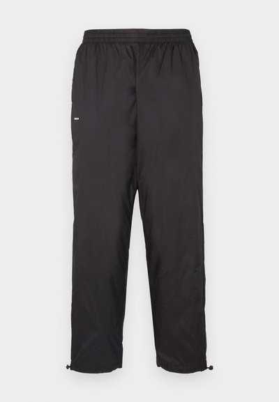 Schwarze wasserdichte Hose mit einem elastischen Bund, tailliertem Bein-Design und verstellbaren Bündchen. Hergestellt aus leichtem, glattem Material.