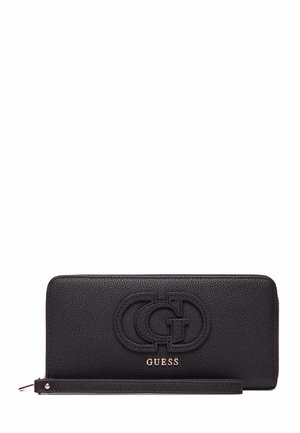 Portefeuille en cuir noir avec une surface texturée, logo et nom de marque en relief. Équipé d'une sangle pour le poignet et de forme rectangulaire.