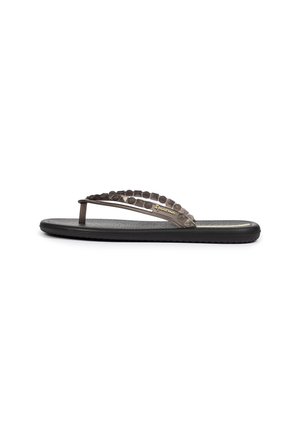 Schwarze Flip-Flop-Sandale mit strukturiertem Gummisohlen, transparentem Riemen mit kreisförmigem Muster und goldfarbigem Logo-Highlight.
