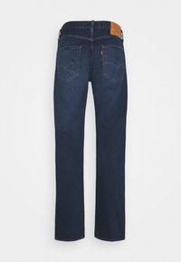 Mörkblå jeans med rak benmodell, med bakfickor och en läderlapp på midjan. Tillverkade av denimmaterial.