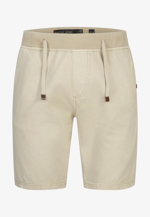 Beiget rentohousut, joissa joustava vyötärö ja kiristysnauha, edessä ompelutaitokset ja keskikokoinen kokoetiketti vyötäröllä sisäpuolella.