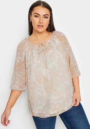 Lettbluse i gennemsigtig stof med et paisley-mønster i pastelfarver. Rund halsudskæring med justerbar snor og ballonsleeves.