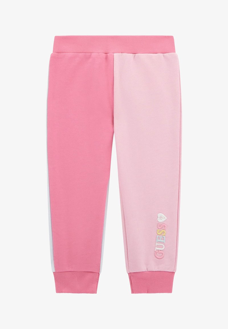 Rozā un gaismas rozā sporta bikses ar ribotu jostasvietu, sašaurinātiem piedurkņu galiem un uzrakstu "GUESS" izšūtu daudzkrāsaini uz kājas.