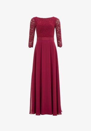 Lungo abito bordeaux con un corpetto di pizzo e maniche in pizzo a tre quarti. La gonna fluente presenta delle pieghe, creando un'elegante silhouette.
