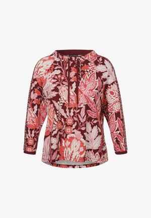 Bloemrijke tuniek in diep bordeauxrood met roze en witte botanische patronen. Heeft een ronde halslijn en driekwart mouwen. Zachte stofuitstraling.