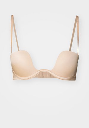 Beige underwired bra with smooth, molded cups and adjustable straps. Features a seamless design and a hook-and-eye closure at the back.