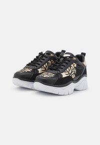 Sneaker neri e oro con motivo, suola bianca spessa, lacci neri e dettagli in rete, angolati per mostrare le viste frontale e laterale.