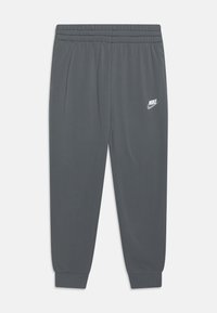 Grå sweatpants i ett slätt, lätt material. Har en elastisk midja och en liten vit Nike-logotyp på övre vänster ben.