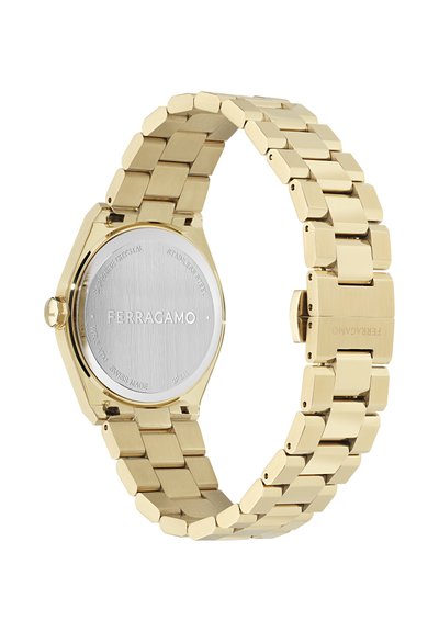 Gold-toned stainless steel watch with an octagonal case, hexagonal bracelet links, polished surface, and engraved brand logo on the back.