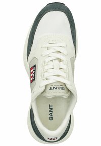 White sneaker with grey suede accents, mesh upper, and a textured sole. Features GANT branding with red and navy stripe details.
