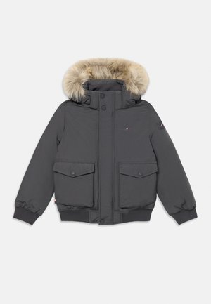 Gray puffer jacket with fur-lined hood, two front pockets, elasticated cuffs, and button closure. Features brand logo on chest.