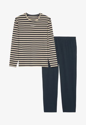 Camicia a maniche lunghe a righe beige e blu navy abbinata a pantaloni blu navy scuri con vita elasticizzata e cordoncino. Materiale in cotone morbido.