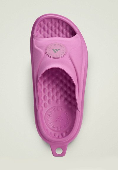 Pink slide sandal made from textured rubber. Features a smooth upper, circular logo on the insole, and a footbed with raised dots for grip.