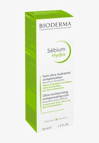 Bioderma Sébium Hydra crèmedoos, voornamelijk wit met groene accenten, bevat tekst in meerdere talen die de hydraterende eigenschappen beschrijft.