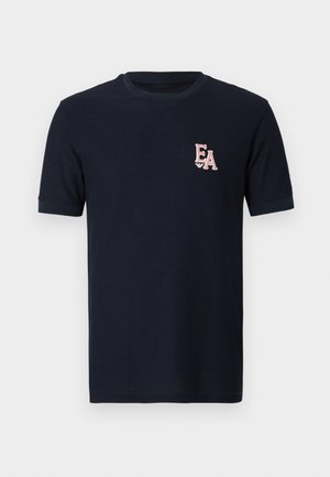 Navy blue short-sleeve t-shirt made of ribbed fabric, featuring a pink "EA" logo embroidered on the left chest. Classic round neckline.