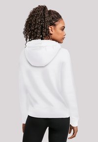 Felpa bianca con cappuccio realizzata in un tessuto morbido e testurizzato. Presenta una vestibilità rilassata, maniche lunghe e orlo e polsini a coste.