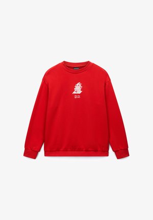 Czerwona bawełniana bluza z długimi rękawami, ściągaczami przy mankietach i u dołu. Na piersi znajduje się biały rysunkowy nadruk przedstawiający robota siedzącego na krześle.