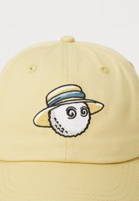 Yellow baseball cap with an embroidered white character wearing a straw hat, featuring a blue and yellow band, and spiral eyes.