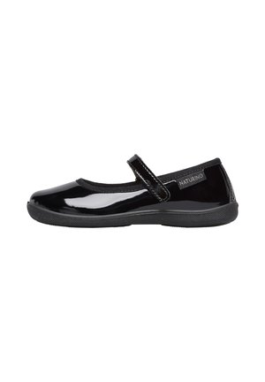 Chaussure Mary Jane en cuir verni noir avec un bout rond, une bride élastique et une semelle en caoutchouc texturée. Marquage discret sur le talon.