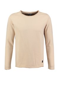 Beige Langarmshirt aus weichem Stoff. Mit rundem Ausschnitt, geradem Schnitt und einem kleinen schwarzen Etikett am unteren Rand.