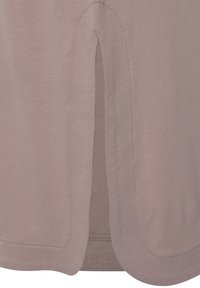 Light mauve shirt featuring a side slit, smooth texture, rounded hem, and stitching details, designed for comfort and ease of movement.