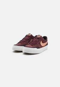 Adidași din suede burgund cu o talpă de cauciuc albă și accente roz deschis. Prezintă șireturi tradiționale și un guler căptușit.