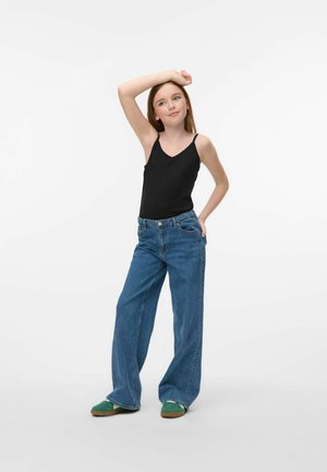 Black spaghetti strap tank top, blue wide-leg jeans, and green shoes. The tank is fitted, while the jeans are loose with a classic denim texture.