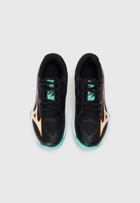 Black athletic shoes with a textured upper, orange accents, and teal soles. Designed for comfort and performance, featuring a lace-up closure.
