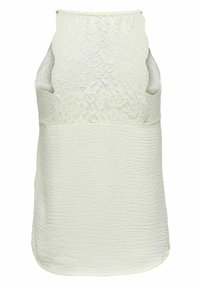 Top senza maniche realizzato in un tessuto bianco texture con sovrapposizione in pizzo sulla parte anteriore. La parte posteriore presenta delle fessure per un ulteriore dettaglio di design.