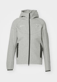 Light gray zip-up jacket with hood. Features black accents on zippers and side pockets, along with a logo on the chest. Soft texture.