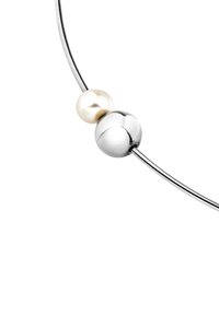 Sølv halskæde med to sfærer: en poleret sølvkugle og en lysende hvid perle, på en tynd metaltråd. Generelt glat tekstur.