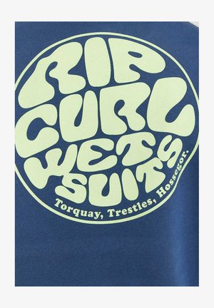 Blauwe stof met een cirkelvormig logo waarop grote, lichtgroene tekst staat "RIP CURL WETSUITS" en "Torquay, Trestles, Hossegor."