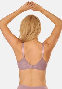 Lavender lace bra with adjustable satin straps, scalloped edges, and a textured pattern, viewed from the back.