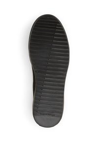 Sola di scarpa in gomma nera con scanalature testurizzate per una migliore aderenza, caratterizzata da un bordo liscio e con la scritta "Made in Portugal" vicino al tallone.
