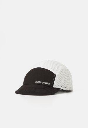 Black and white cap featuring a breathable mesh design, a solid black front panel, and "patagonia" embroidered in gray on the side.