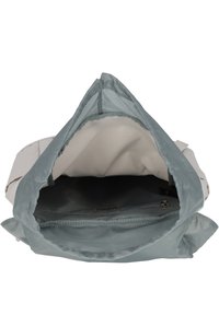 Light gray backpack with a soft, textured exterior. Interior features a spacious compartment with a smooth, light blue lining and a zippered pocket.