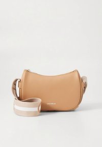 Tan leather crossbody bag with a curved shape, featuring a beige strap with white stripes and a zip closure. Minimal branding visible.