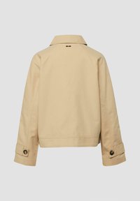 Beige long-sleeve jacket with collar, buttoned cuffs, and a small black detail below the collar, shown from the back.