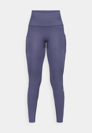 Leggings deportivos de talle alto, sin costuras, en color azul marino, con bolsillos laterales y un sutil patrón texturizado, diseñados para ropa de actividad.