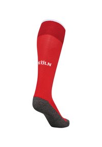 Calza rossa al ginocchio con fascia bianca in alto, con la scritta "KÖLN" in bianco sul lato e una sezione centrale nera texturizzata.