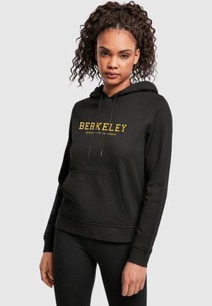 Hoodie noir en tissu doux, avec une poche frontale, un capuche à cordon de serrage et un graphique "BERKELEY" en jaune sur la poitrine.