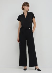 Calliope LUNGO BOTTONE - Pantaloni - nero
